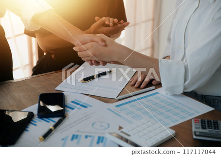 Leaders of business organizations join hands after the meeting is complete. Business partner meeting ideas. 117117044