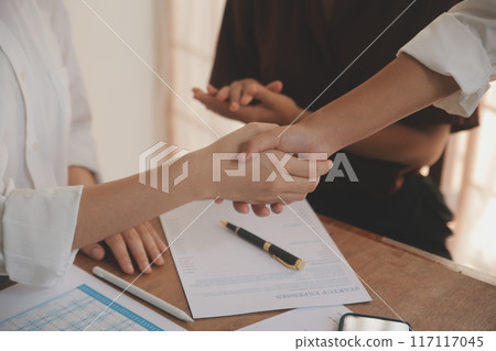 Leaders of business organizations join hands after the meeting is complete. Business partner meeting ideas. 117117045