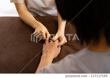 A chiropractor undergoing training in hand care A chiropractor undergoing training in hand care 117117589