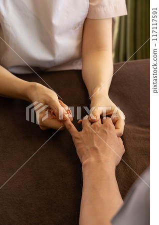 A chiropractor undergoing training in hand care A chiropractor undergoing training in hand care 117117591