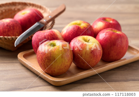 Red apple fruit (Envy apple) on wooden plate with knife ready to eating, Healthy fruit 117118003