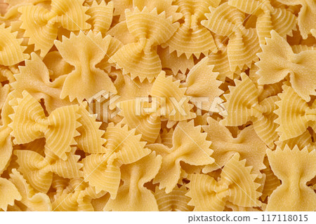 Uncooked farfalle pasta (bow tie shape) texture background, Italian food ingredient 117118015