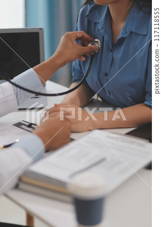 Doctor using a stethoscope checking patient with examining, presenting results symptom and recommend treatment method, Healthcare and medical concept. 117118555