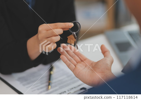 Sale representative offer house purchase contract to buy a house or apartment or discussing about loans and interest rates 117118614