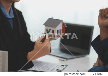Sale representative offer house purchase contract to buy a house or apartment or discussing about loans and interest rates Sale representative offer house purchase contract to buy a house or apartment or discussing about loans and interest rates 117118619