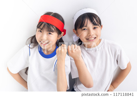 A girl wearing a headband and raising her fist in celebration 117118841