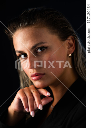 Close up of womans face with hand on chin, including different facial features Close up of womans face with hand on chin, including different facial features 117120484
