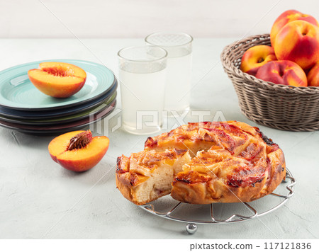 Vegan nectarine peach cake on turquoise table, summer treat Vegan nectarine peach cake on turquoise table, summer treat 117121836