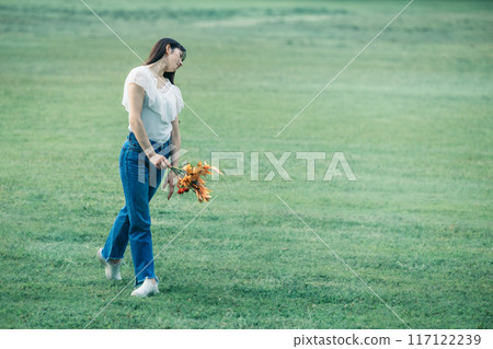 A female ballerina dancing surrounded by soft natural greenery A female ballerina dancing surrounded by soft natural greenery 117122239
