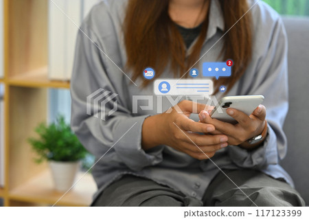 Woman hand typing on mobile phone commenting in online community. Social media and technology concept Woman hand typing on mobile phone commenting in online community. Social media and technology concept 117123399