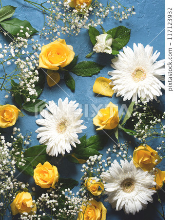 Floral background with yellow and white flowers on blue 117123932