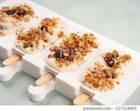 Homemade greek yogurt icecream popsicles in silicone moulds 117124003