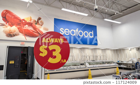 Close-up of always $3 per bound sign hanging on the roof Inside a Superstore in Coquitlam. 117124009