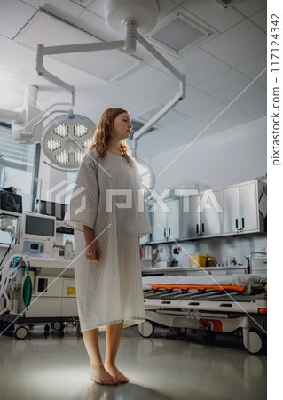 Low angle view of patient in hospital gown in emergency room. Looking like angel. 117124342