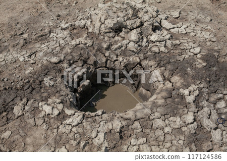 Mud geyser with dark dirty water outdoor 117124586