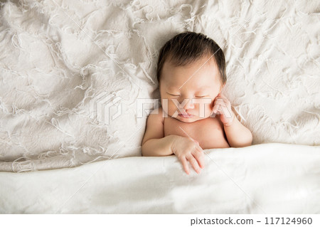 Cute newborn baby sleeping soundly 117124960