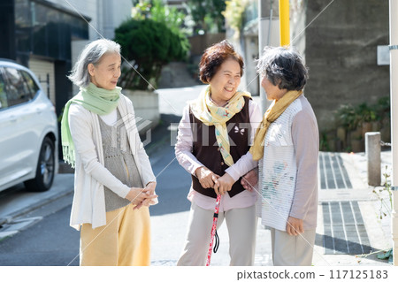 Three senior women standing and talking Three senior women standing and talking 117125183