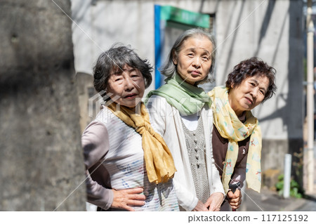 Three senior women standing and talking Three senior women standing and talking 117125192