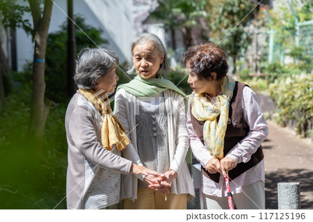 Three senior women standing and talking Three senior women standing and talking 117125196