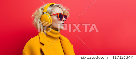 Portrait of a young woman wearing hightech equipment .glasses and headphones on red background 117125347