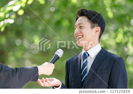 A man giving a passionate speech during a street interview 117125839