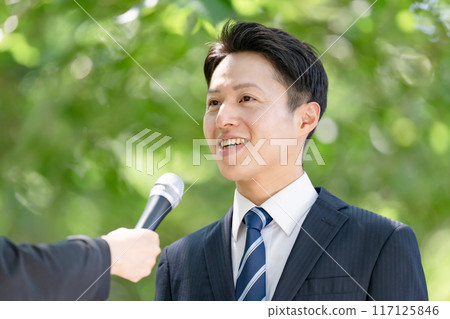 A man giving a passionate speech during a street interview A man giving a passionate speech during a street interview 117125846