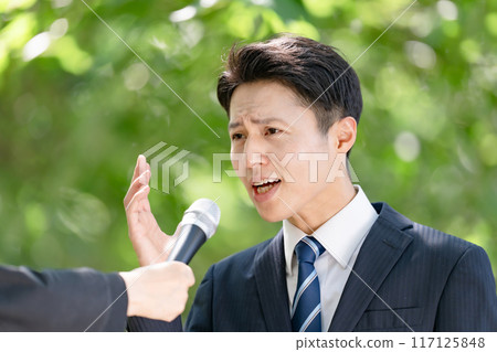 A man giving a passionate speech during a street interview 117125848