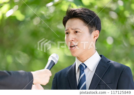 A man giving a passionate speech during a street interview 117125849
