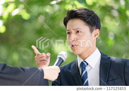 A man giving a passionate speech during a street interview 117125853