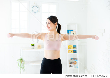Woman doing muscle training Woman doing muscle training 117125877