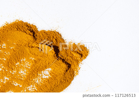 Scattered ground turmeric root on white background, spice texture, copy space for text 117126513