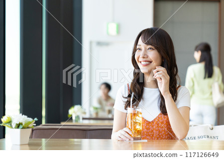 A young woman relaxing in a cafe A young woman relaxing in a cafe 117126649