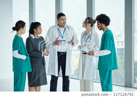 Doctors Discussing Diagnosis In Team 117126792