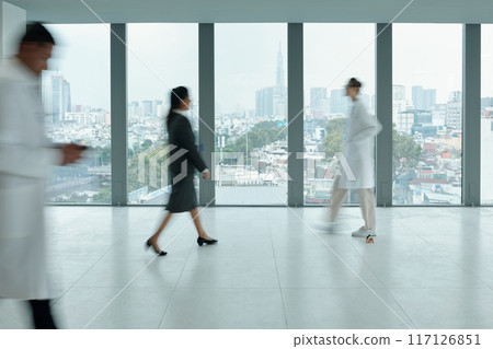 People Walking In Corridor Of Hospital People Walking In Corridor Of Hospital 117126851
