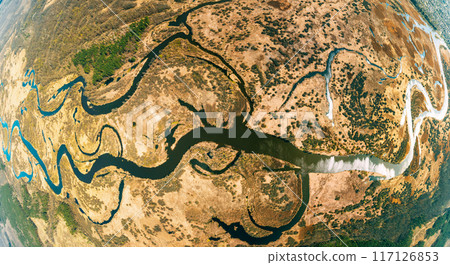 Aerial View Green Countryside Rural forest river Field Meadow Landscape Sunny summer Day. Top View Of Beautiful Nature From High Attitude. Little Small Planet Concept 117126853