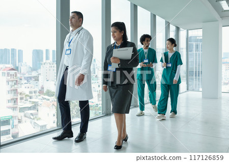 Manager Of Clinic Talking To Doctor In Corridor 117126859