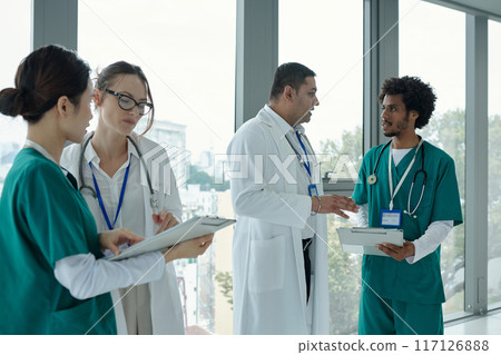 Doctors Examining Medical Cards Of Patients Doctors Examining Medical Cards Of Patients 117126888