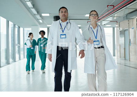 Doctors Walking Together In Corridor 117126904
