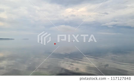 Smooth lake with reflective sky Smooth lake with reflective sky 117127848