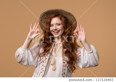 Pretty woman with OKAY sign, ok gesture. Happy lady, correct choice, beige wall Pretty woman with OKAY sign, ok gesture. Happy lady, correct choice, beige wall 117128403