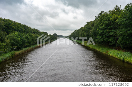 The Twente Canal and green banks on a grey, rainy day around Goor, Overijssel, The Netherlands 117128692