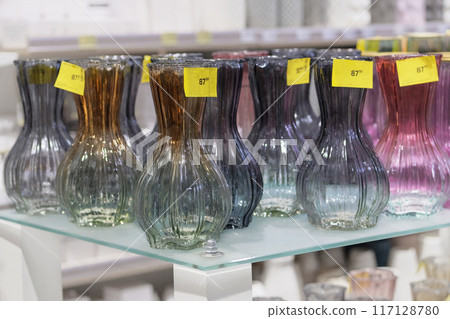 Colored glass vases are sold in store. Jars for flowers. 117128780