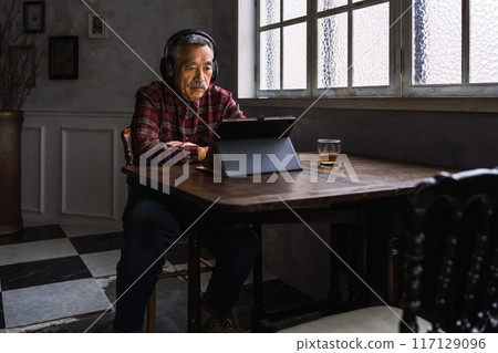 Senior man looking at tablet Senior man looking at tablet 117129096
