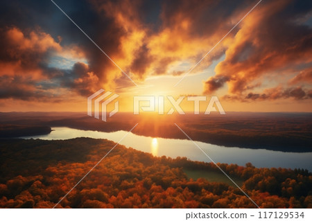 a beautiful dramatic sunset sky with cumulus clouds over the forest and river, a bird's-eye view 117129534