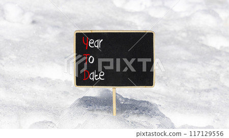 YTD year to date symbol. Concept words YTD year to date on beautiful yellow blackboard. Beautiful white snow background. Business YTD year to date concept. Copy space. YTD year to date symbol. Concept words YTD year to date on beautiful yellow blackboard. Beautiful white snow background. Business YTD year to date concept. Copy space. 117129556