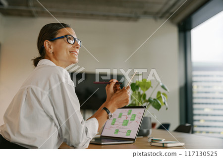 A Professional Woman Working in a Modern Office Environment While Engaging with Her Laptop A Professional Woman Working in a Modern Office Environment While Engaging with Her Laptop 117130525