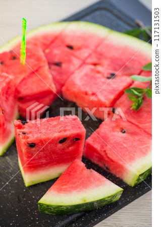 pieces of ripe red watermelon, close-up, on a board pieces of ripe red watermelon, close-up, on a board 117131503