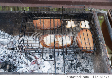 Outdoor Grilling Fish Steaks on Open Fire 117131573