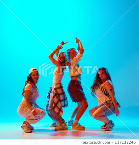 Talented dancers in casual outfits strike stylish poses against blue gradient background, demonstrate unique personalities and dynamic energy. 117132240