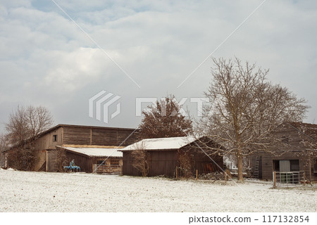 Winter Wonderland: Snow-Covered European Village Countryside. A Snow-Covered European Village in the Picturesque Countryside 117132854